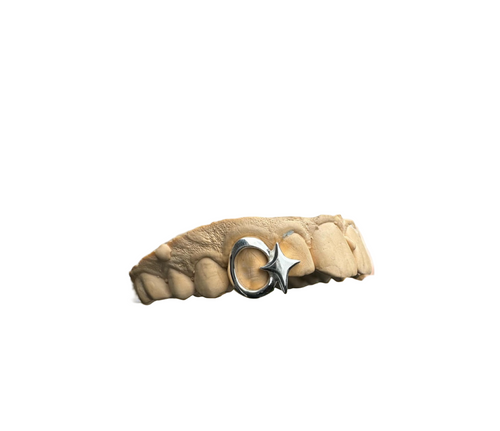 Twin silver grillz with a window and 4-point star design on a white background, with the brand name 'CAPPD'
